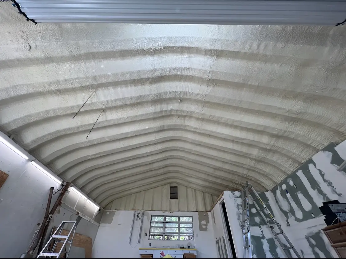 Spray polyurethane foam applied to the underside of a metal roof deck in Troy
